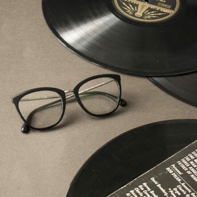 Glasses next to some records