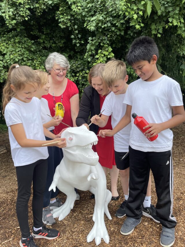 Diss school children painting t-rex sculpture