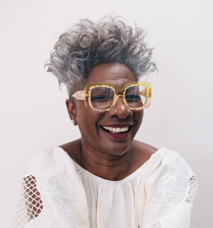 Lady in large yellow glasses laughing